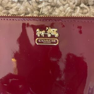 Red patent leather wristlet by Coach. Excellent condition inside and out.